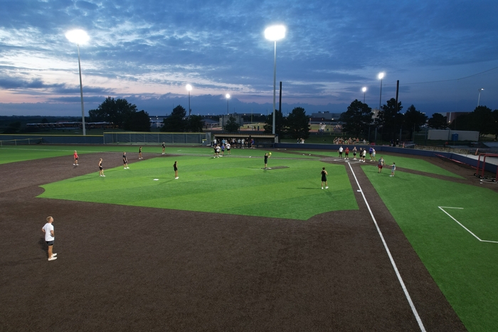 students playing kickball on the baseball field