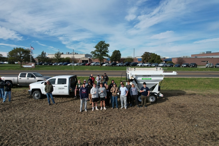 students pose in front of grain cart