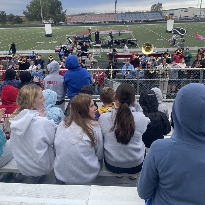 5th graders sitting in stands watching band perform