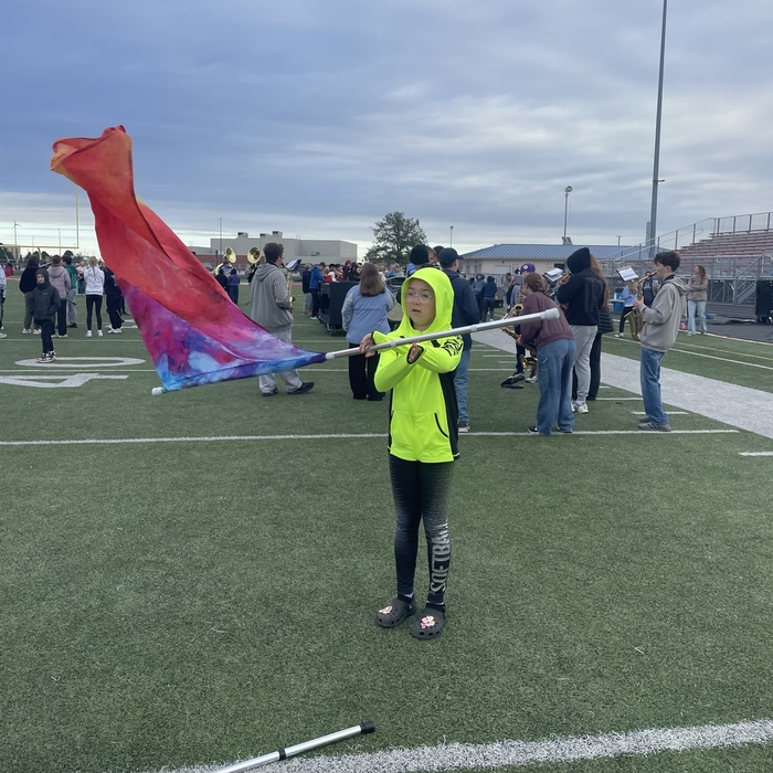 5th grader practices spinning a flag